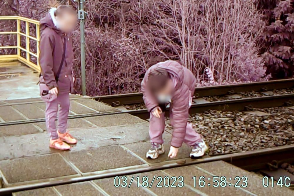 two boys placing ballast stones on the track so they are run over by trains © Network Rail